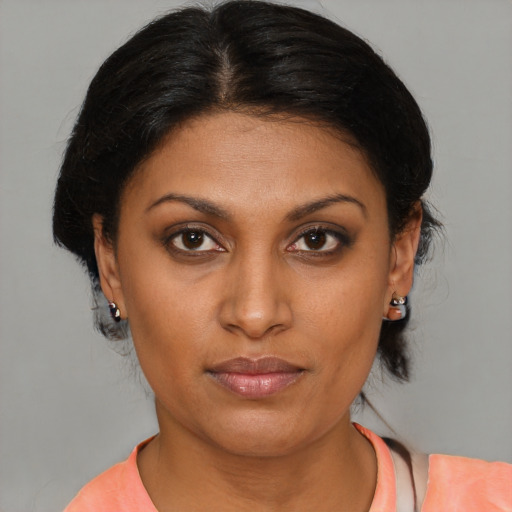 Joyful black young-adult female with medium  brown hair and brown eyes