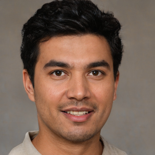 Joyful white young-adult male with short  black hair and brown eyes