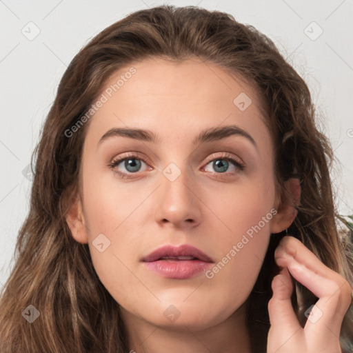 Neutral white young-adult female with long  brown hair and green eyes