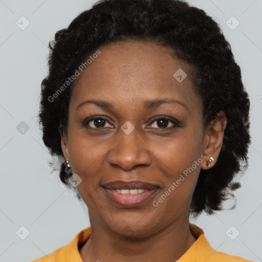 Joyful black adult female with short  brown hair and brown eyes