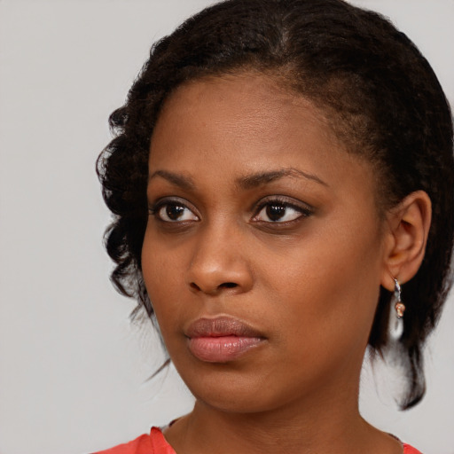 Neutral black young-adult female with medium  brown hair and brown eyes