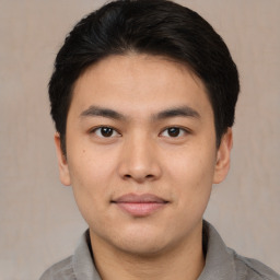 Joyful asian young-adult male with short  black hair and brown eyes