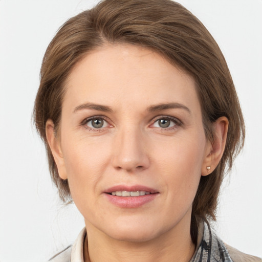 Joyful white young-adult female with medium  brown hair and grey eyes