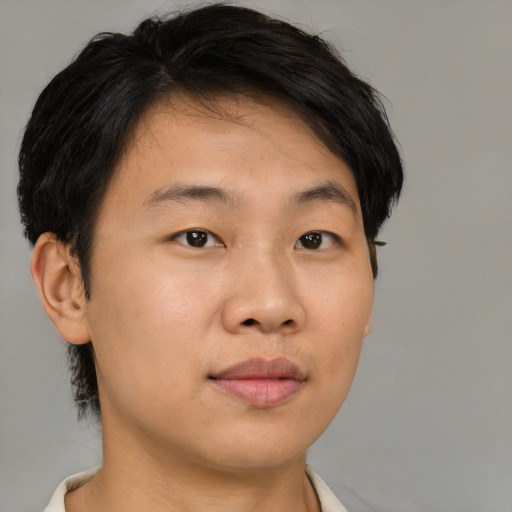 Joyful asian young-adult male with short  brown hair and brown eyes