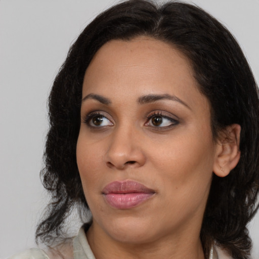 Joyful black young-adult female with medium  brown hair and brown eyes