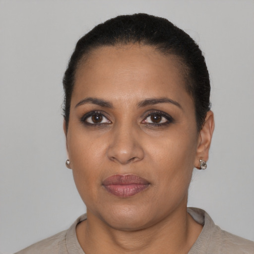 Joyful black adult female with short  black hair and brown eyes