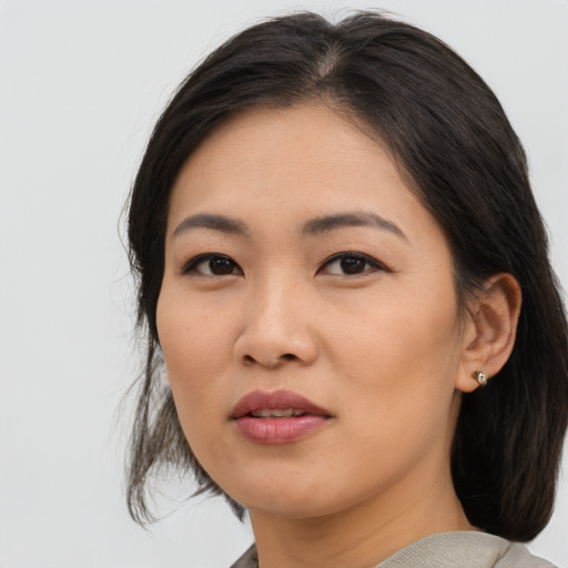 Joyful asian young-adult female with medium  black hair and brown eyes