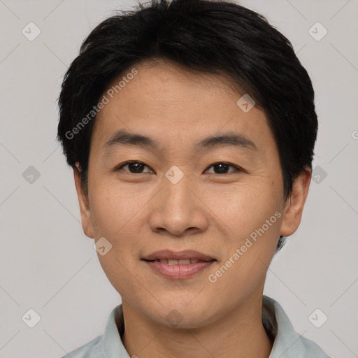 Joyful asian young-adult male with short  brown hair and brown eyes