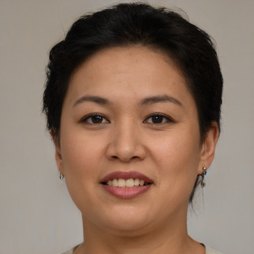 Joyful asian young-adult female with short  brown hair and brown eyes