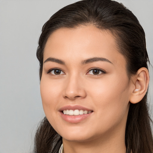 Joyful white young-adult female with long  brown hair and brown eyes