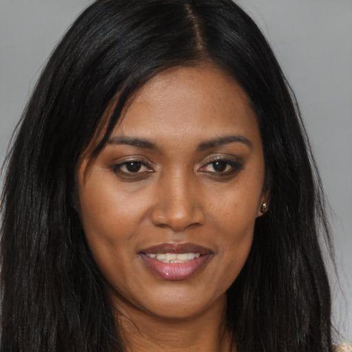 Joyful asian young-adult female with long  brown hair and brown eyes