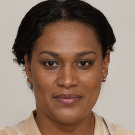 Joyful black adult female with short  brown hair and brown eyes