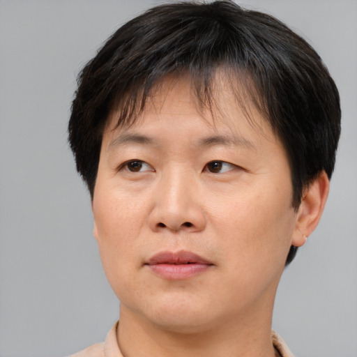 Joyful asian adult female with short  brown hair and brown eyes