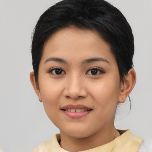 Joyful asian young-adult female with short  brown hair and brown eyes