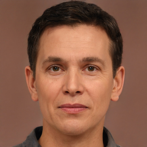 Joyful white adult male with short  brown hair and brown eyes