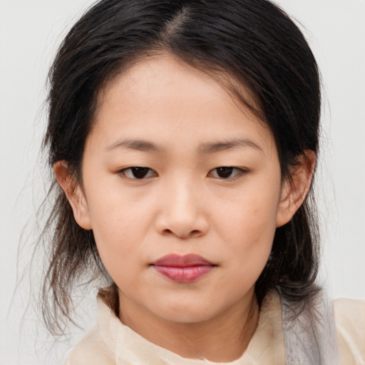 Joyful asian child female with medium  brown hair and brown eyes