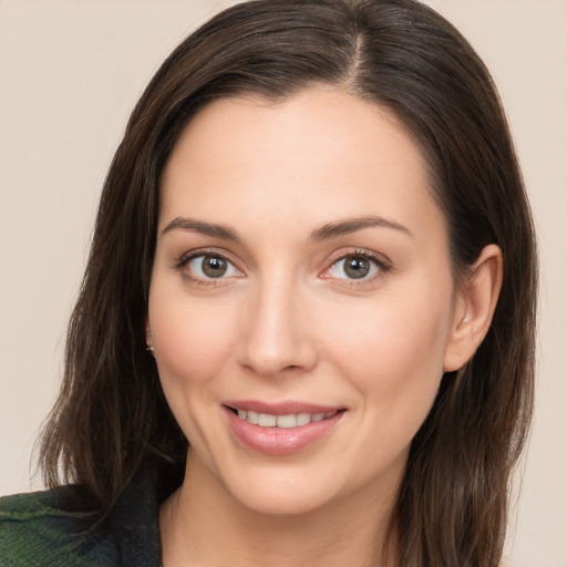 Joyful white young-adult female with long  brown hair and brown eyes