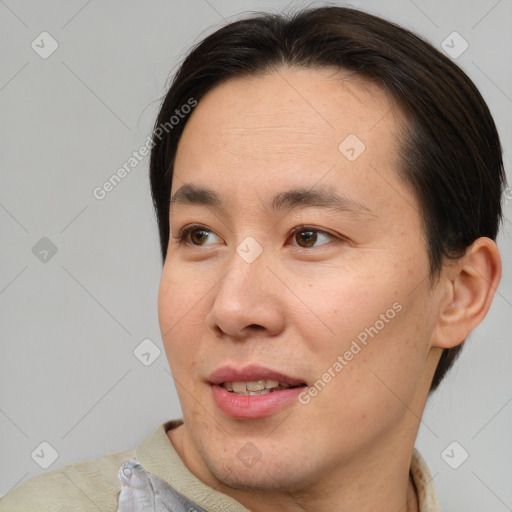 Joyful asian young-adult male with short  brown hair and brown eyes