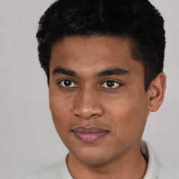 Joyful latino young-adult male with short  black hair and brown eyes