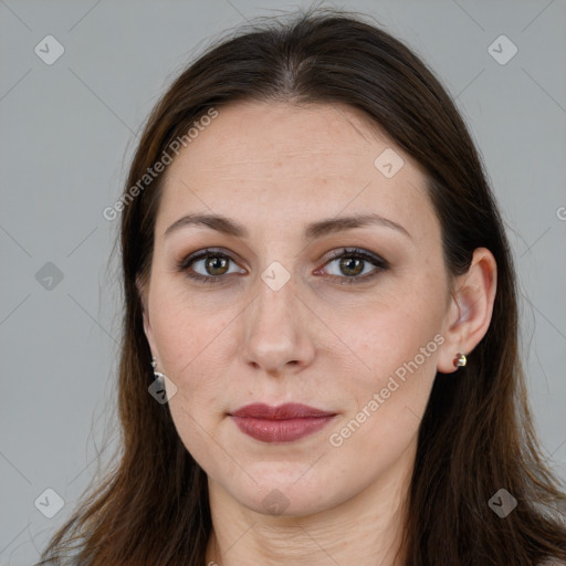 Joyful white adult female with long  brown hair and brown eyes