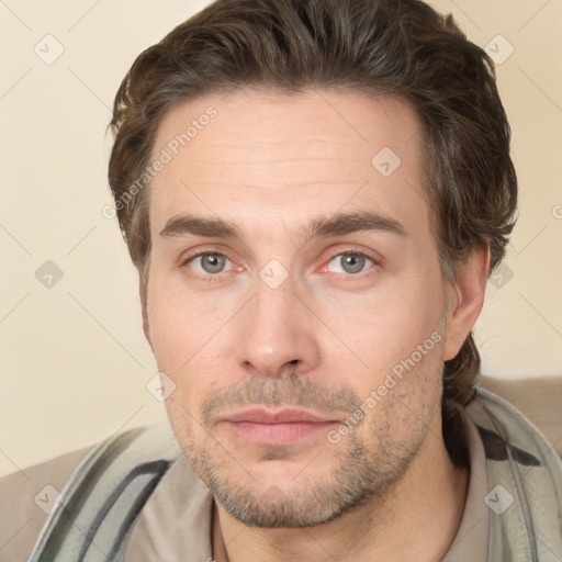 Joyful white adult male with short  brown hair and brown eyes