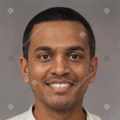 Joyful latino young-adult male with short  black hair and brown eyes