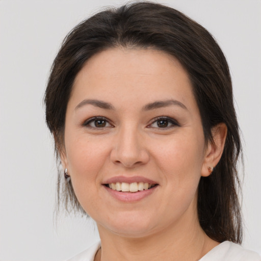 Joyful white young-adult female with medium  brown hair and brown eyes
