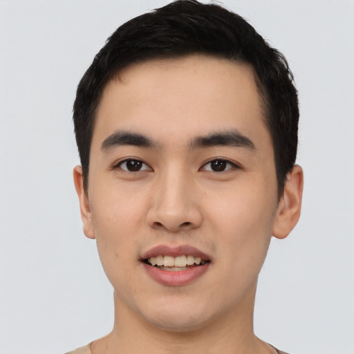 Joyful asian young-adult male with short  black hair and brown eyes