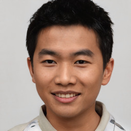 Joyful asian young-adult male with short  black hair and brown eyes