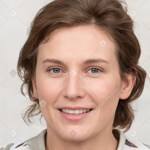 Joyful white young-adult female with medium  brown hair and blue eyes