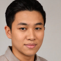 Joyful latino young-adult male with short  brown hair and brown eyes