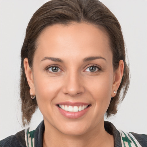 Joyful white young-adult female with medium  brown hair and brown eyes