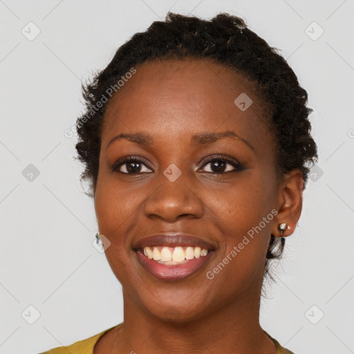 Joyful black young-adult female with short  brown hair and brown eyes