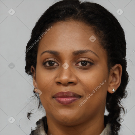 Joyful black young-adult female with long  brown hair and brown eyes