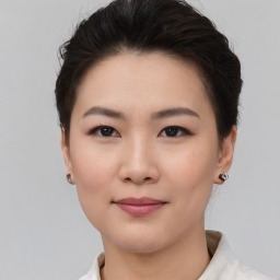 Joyful asian young-adult female with short  brown hair and brown eyes