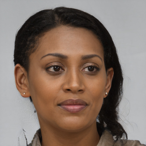 Joyful black young-adult female with medium  brown hair and brown eyes