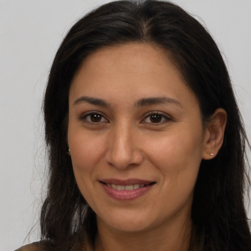 Joyful latino young-adult female with long  brown hair and brown eyes