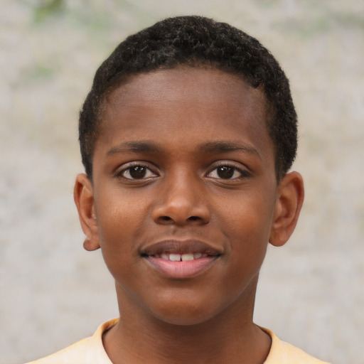 Joyful black child male with short  brown hair and brown eyes