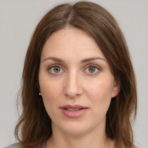 Joyful white young-adult female with medium  brown hair and green eyes