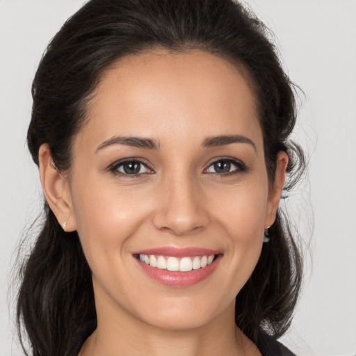 Joyful white young-adult female with long  brown hair and brown eyes