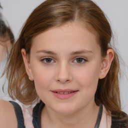 Joyful white child female with medium  brown hair and brown eyes