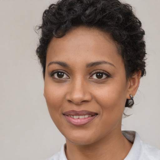 Joyful latino young-adult female with short  brown hair and brown eyes