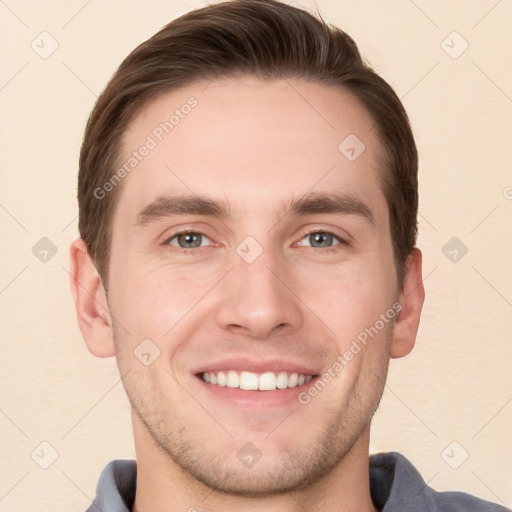 Joyful white young-adult male with short  brown hair and grey eyes