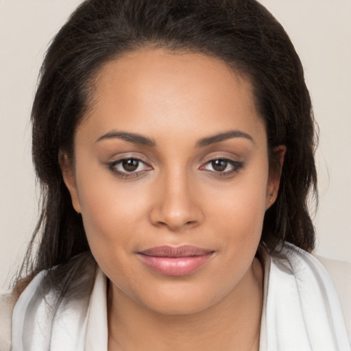 Joyful white young-adult female with long  brown hair and brown eyes