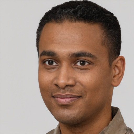 Joyful black young-adult male with short  black hair and brown eyes