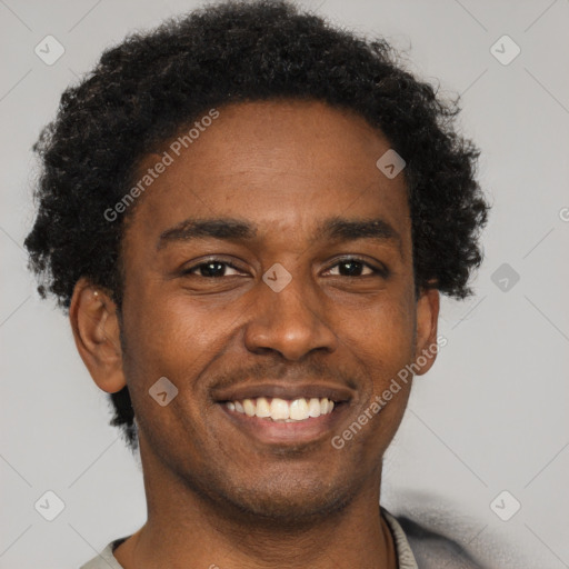 Joyful black young-adult male with short  brown hair and brown eyes