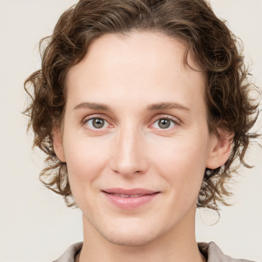 Joyful white young-adult female with medium  brown hair and green eyes