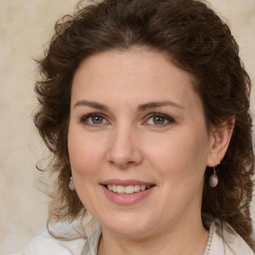 Joyful white young-adult female with medium  brown hair and green eyes