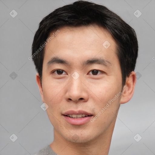 Joyful asian young-adult male with short  brown hair and brown eyes