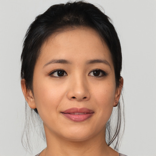 Joyful asian young-adult female with medium  black hair and brown eyes